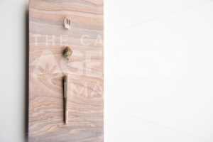 Marijuana Bud, Joint and Crystal on a Desert Stone, Landscape Orientation – Minimalist Cannabis - The Cannabiz Agency